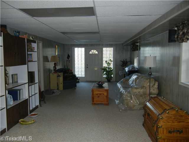 6307 Nat Road Julian, NC 27283 - Photo 13 of 15 Den/Family/Great Room. Huge downstairs Great Room with its own entrance, and enclosed one car garage.
