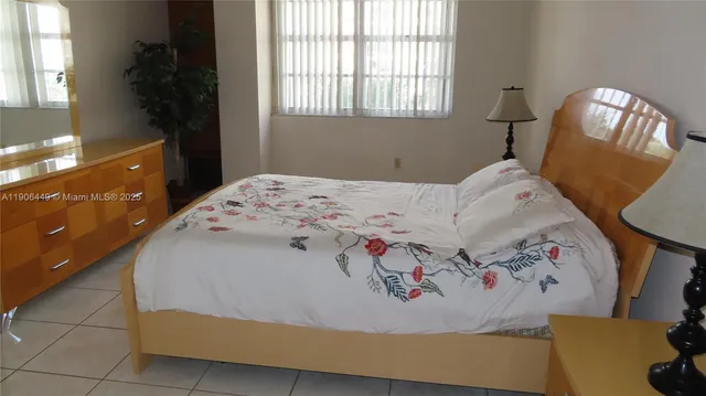 a bathroom with a toilet and a shower curtain