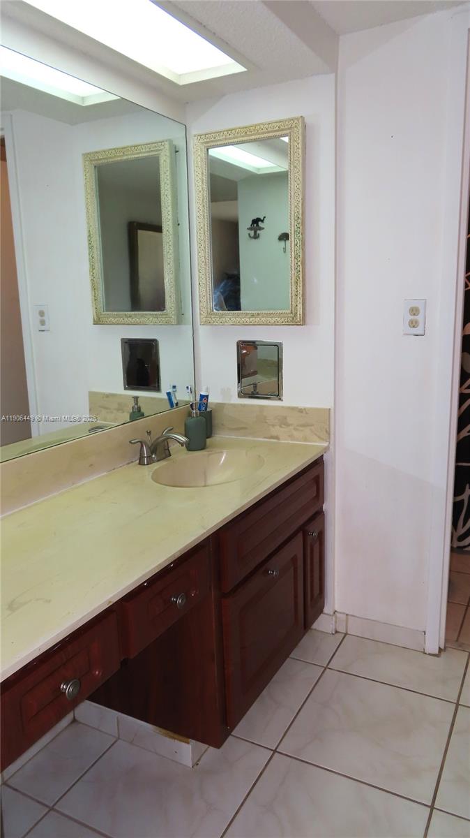 5701 Collins Avenue, Unit 511 Miami Beach, FL 33140 - Photo 18 of 51 a bathroom with a sink and a mirror