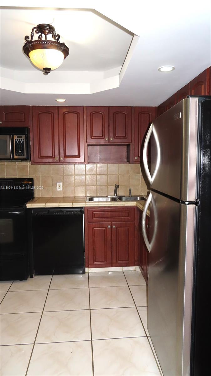 5701 Collins Avenue, Unit 511 Miami Beach, FL 33140 - Photo 9 of 51 a kitchen with a cabinets and a sink