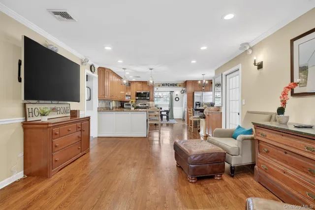 a living room with fireplace furniture and a chandelier