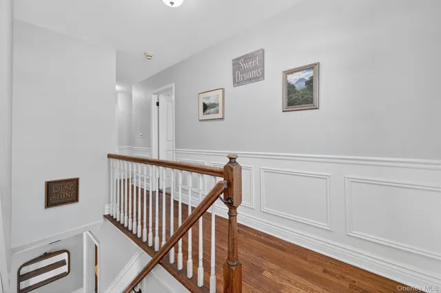 a living room with furniture and a flat screen tv with wooden floor