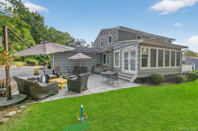 a patio with a table and chairs under an umbrella