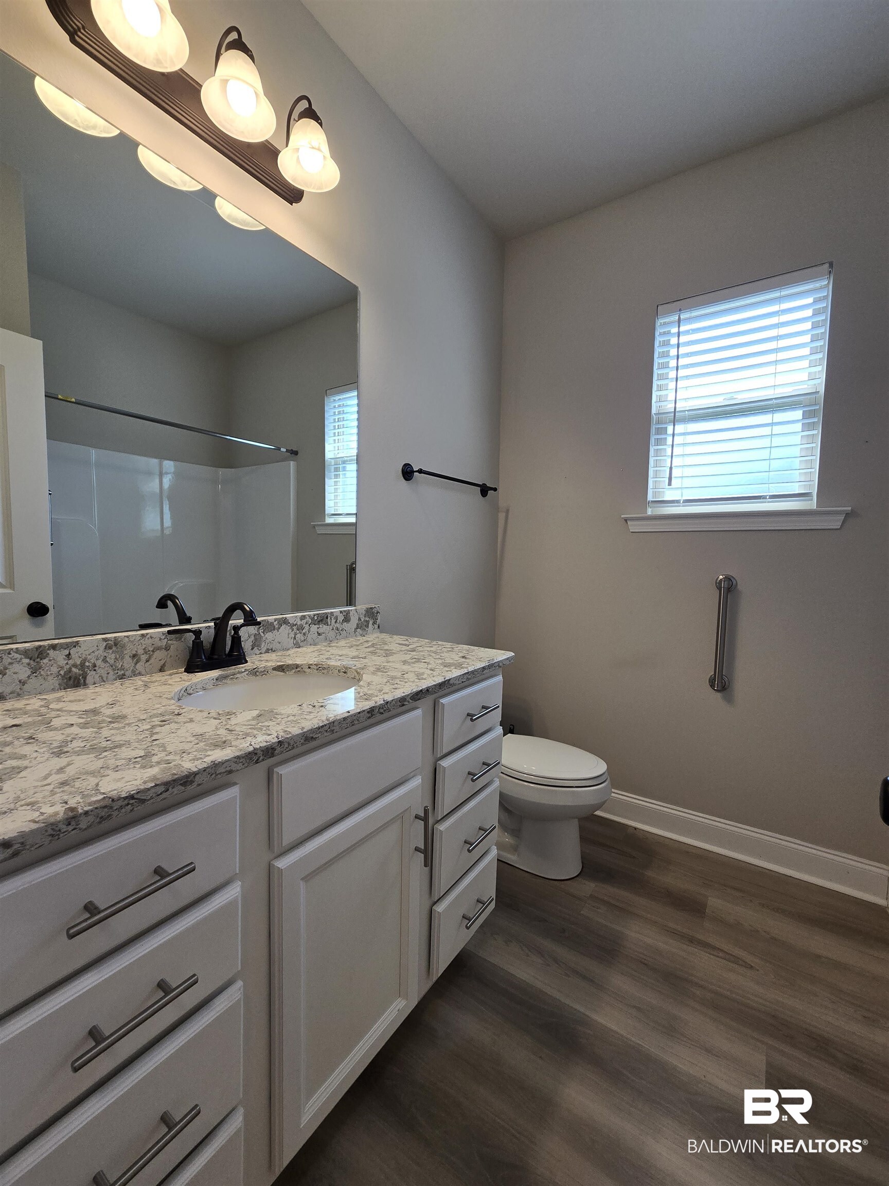 1060 Chloe Street Foley, AL 36535 - Photo 21 of 28 Bathroom vanity featuring a single basin, dark bronze faucet, and a light-toned countertop
