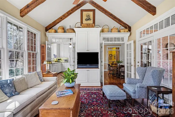 a living room with furniture a fireplace and a flat screen tv