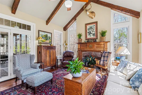 a living room with furniture a window and a flat screen tv