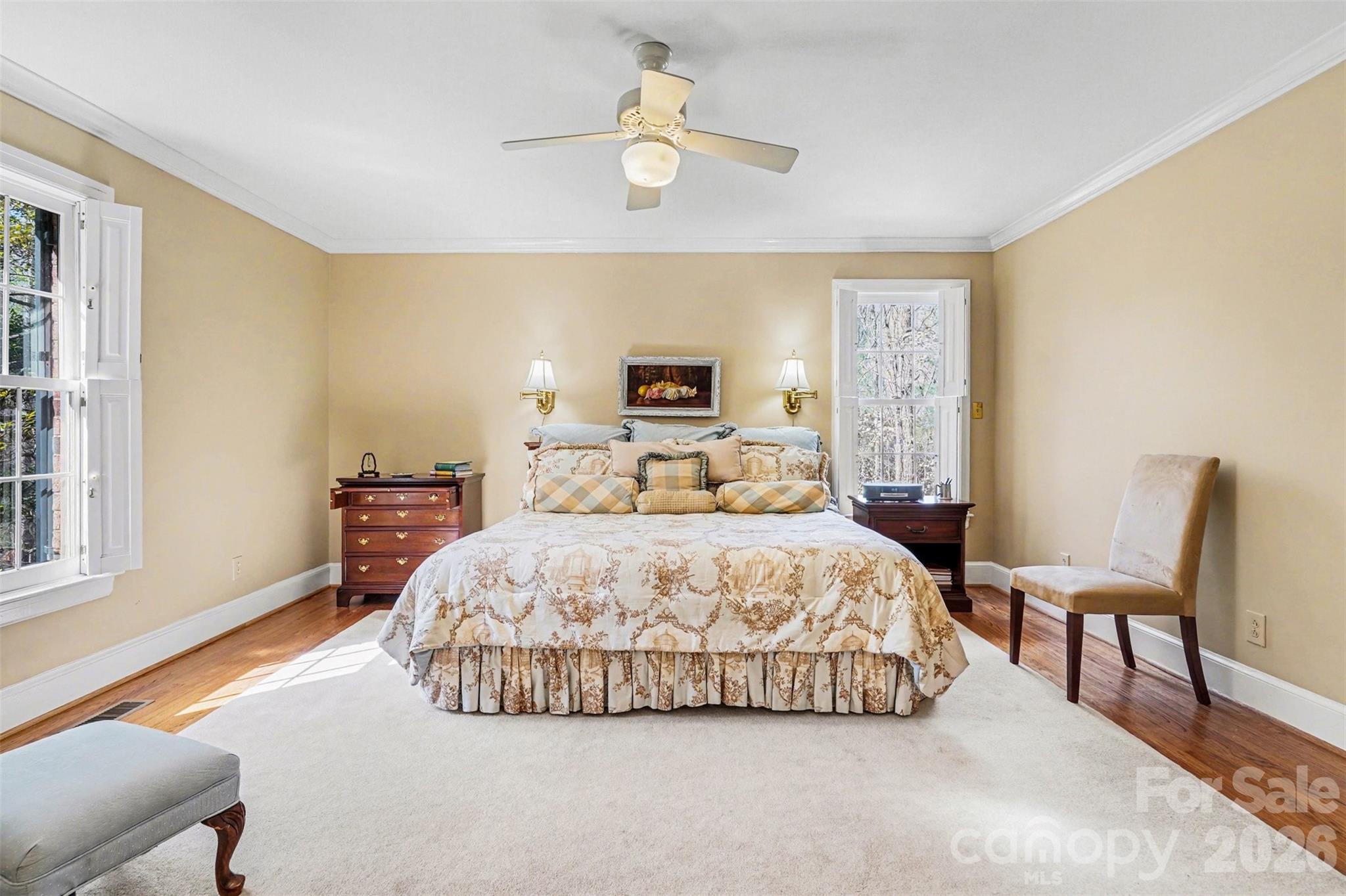 212 Deer Chase Road Shelby, NC 28150 - Photo 23 of 40 a spacious bedroom with a bed a chandelier and a window