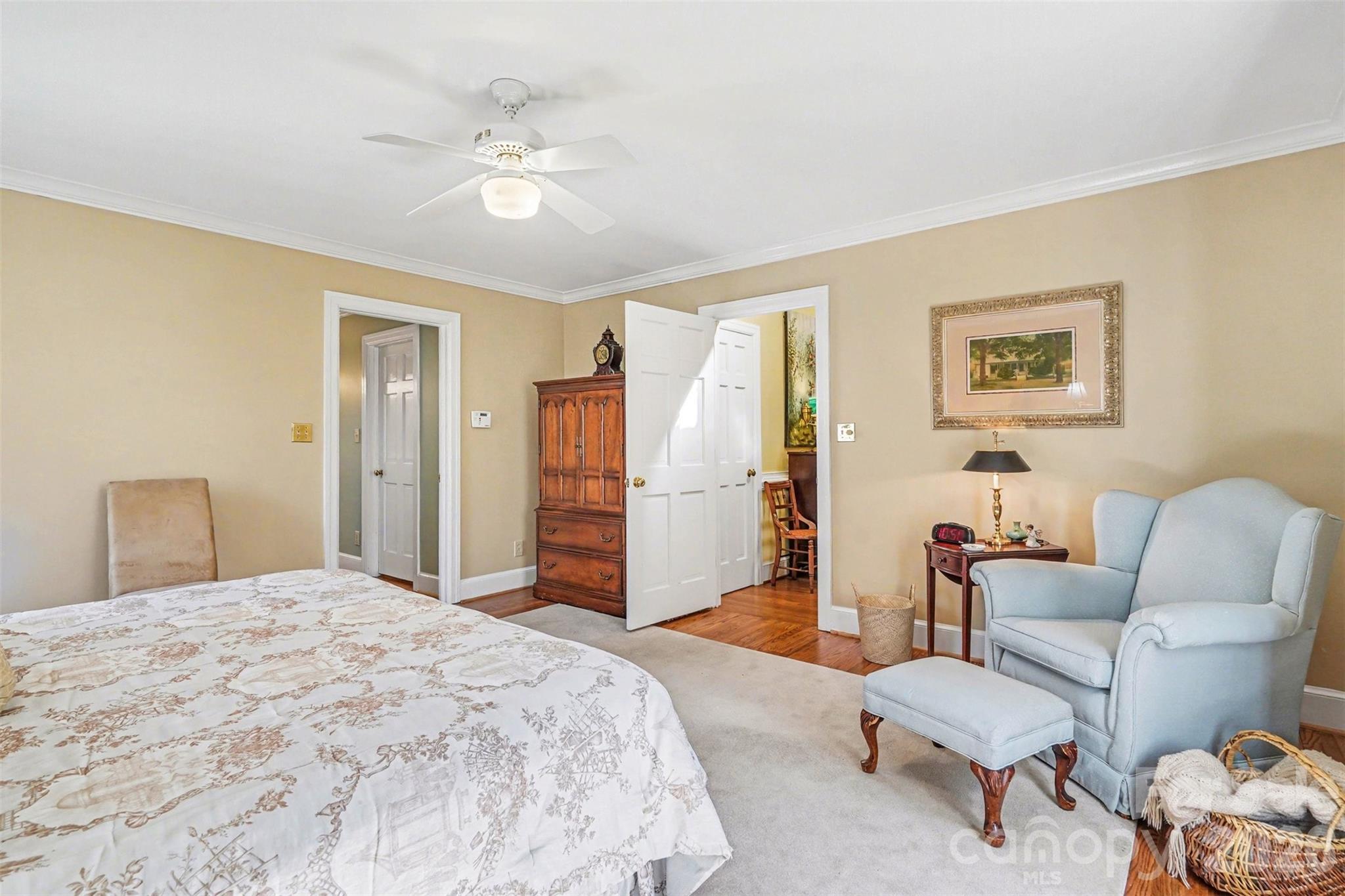 212 Deer Chase Road Shelby, NC 28150 - Photo 24 of 40 a spacious bedroom with a bed a couch and a chandelier