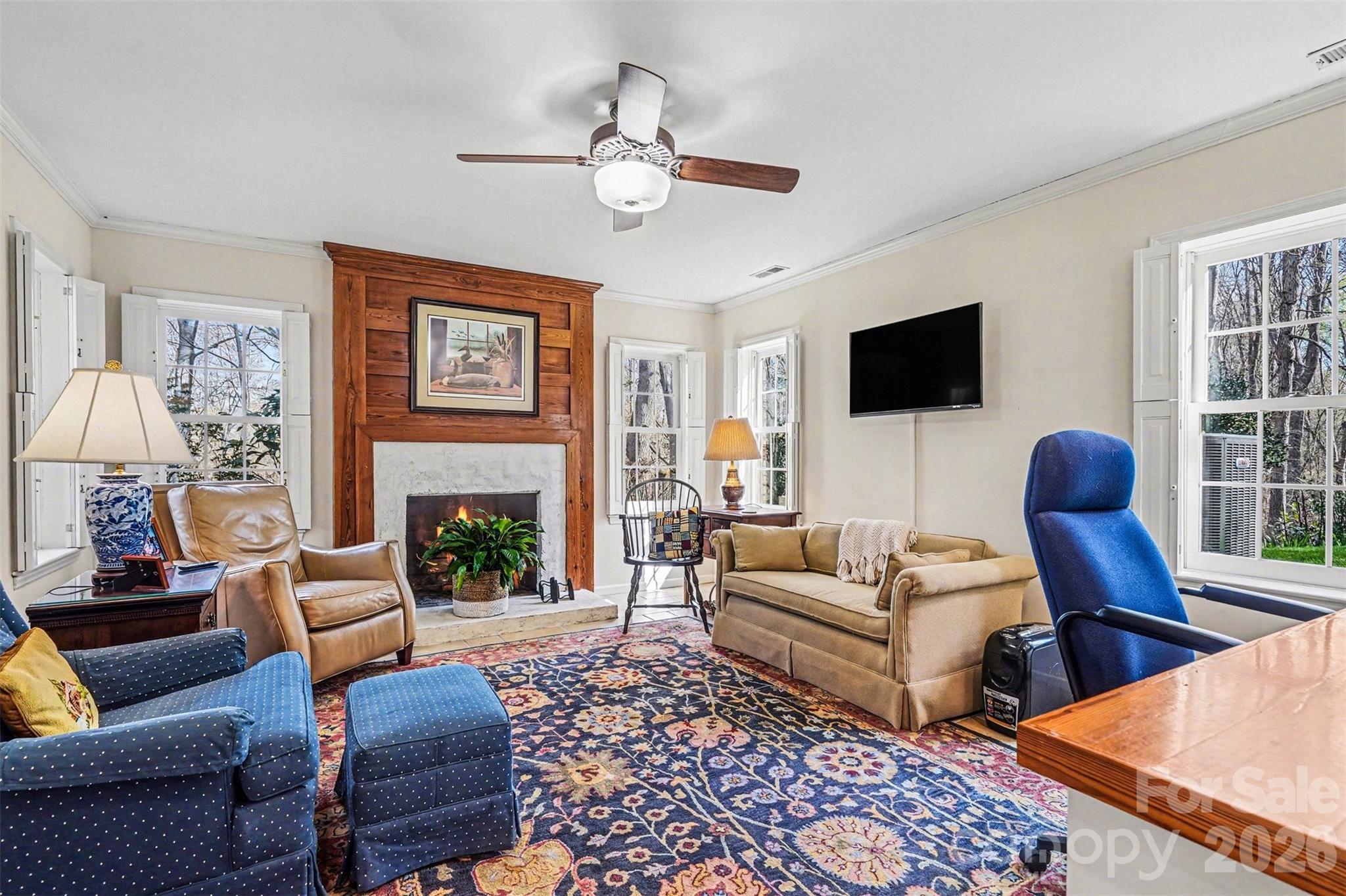 212 Deer Chase Road Shelby, NC 28150 - Photo 28 of 40 a living room with furniture a fireplace and a flat screen tv