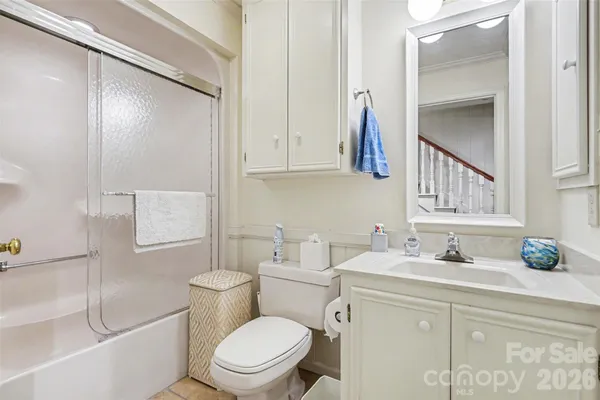 a bathroom with a sink a toilet and a mirror