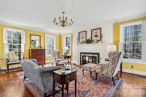 a view of a livingroom with furniture a fireplace and wooden floor