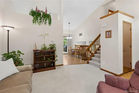 a living room with furniture and stairs