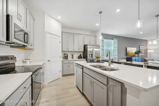 a kitchen with stainless steel appliances granite countertop a sink stove and cabinets