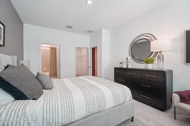 a bedroom with a bed and a dresser