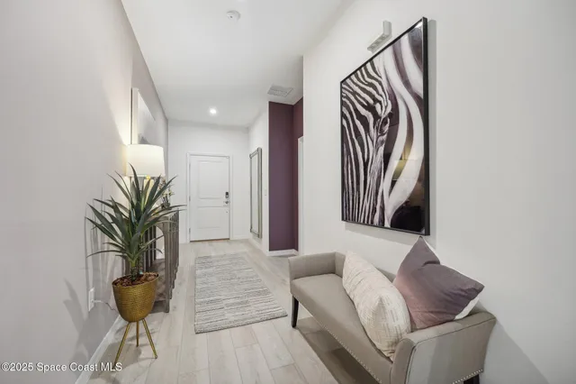 a living room with furniture and a potted plant