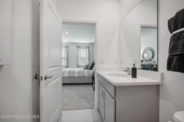 a en suite bathroom with a sink and mirror