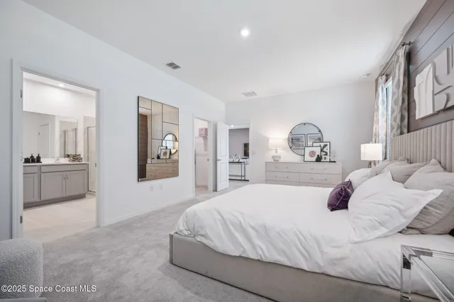 a bedroom with a large bed and a view of bathroom