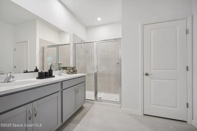 a bathroom with a double vanity sink and mirror