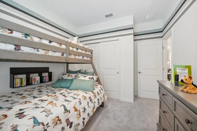 a bedroom with a bed and a dresser
