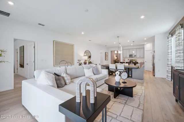 a living room with lots of furniture a rug and a table