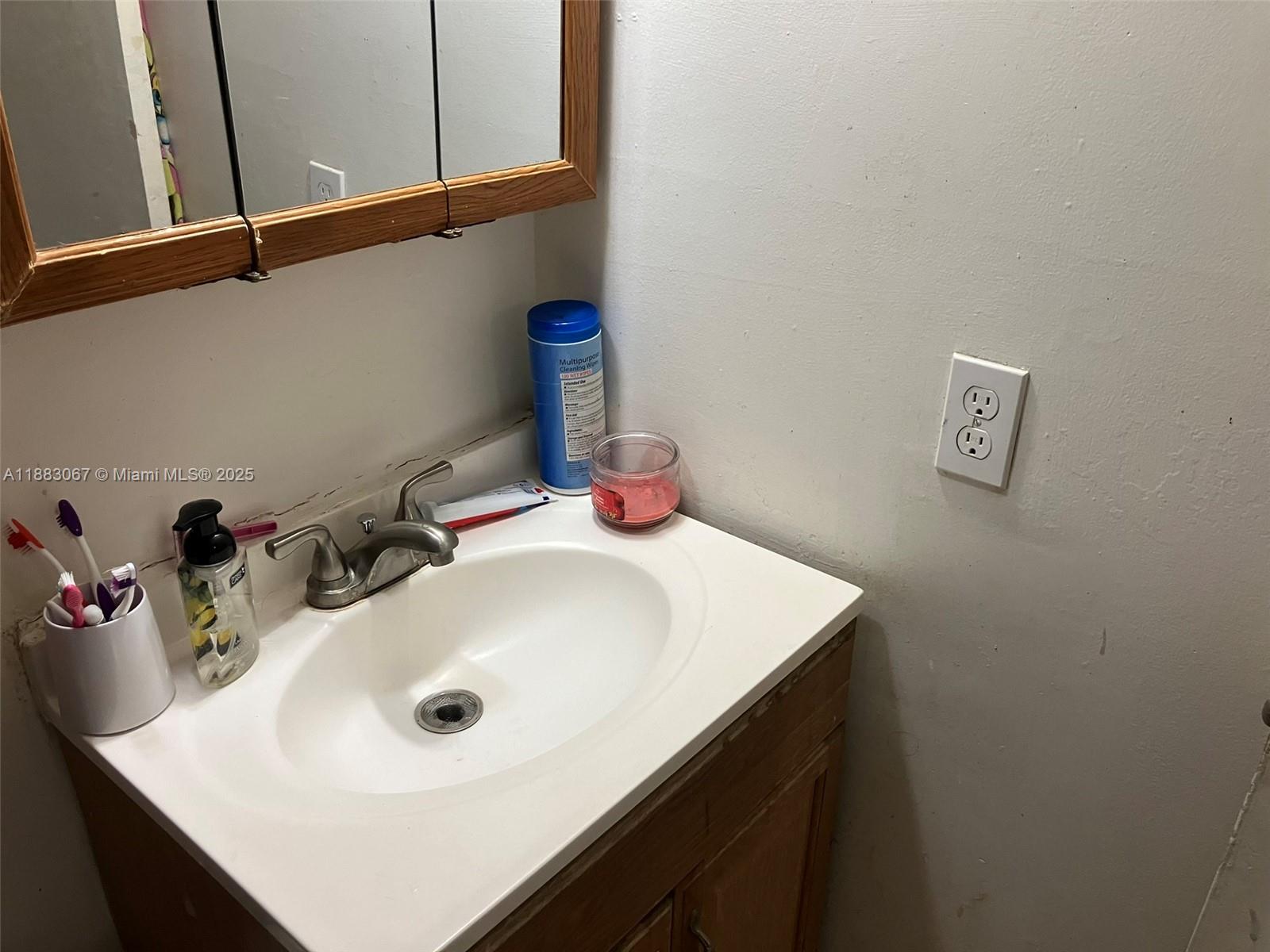 9311 Southwest 4th Street, Unit 104B Miami, FL 33174 - Photo 11 of 21 a bathroom with a sink and a mirror