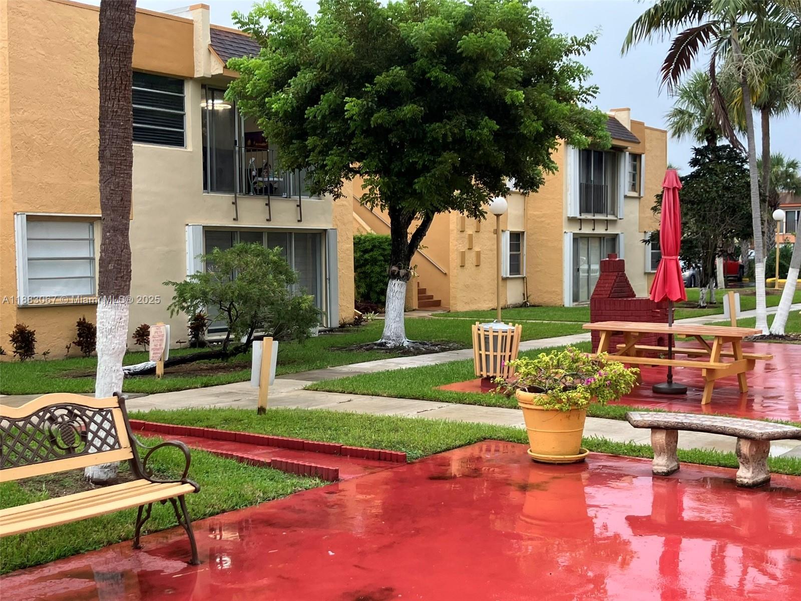 9311 Southwest 4th Street, Unit 104B Miami, FL 33174 - Photo 17 of 21 a view of a house with backyard porch and sitting area