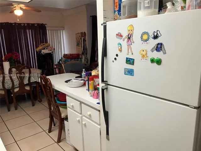 a white refrigerator freezer sitting inside of a kitchen