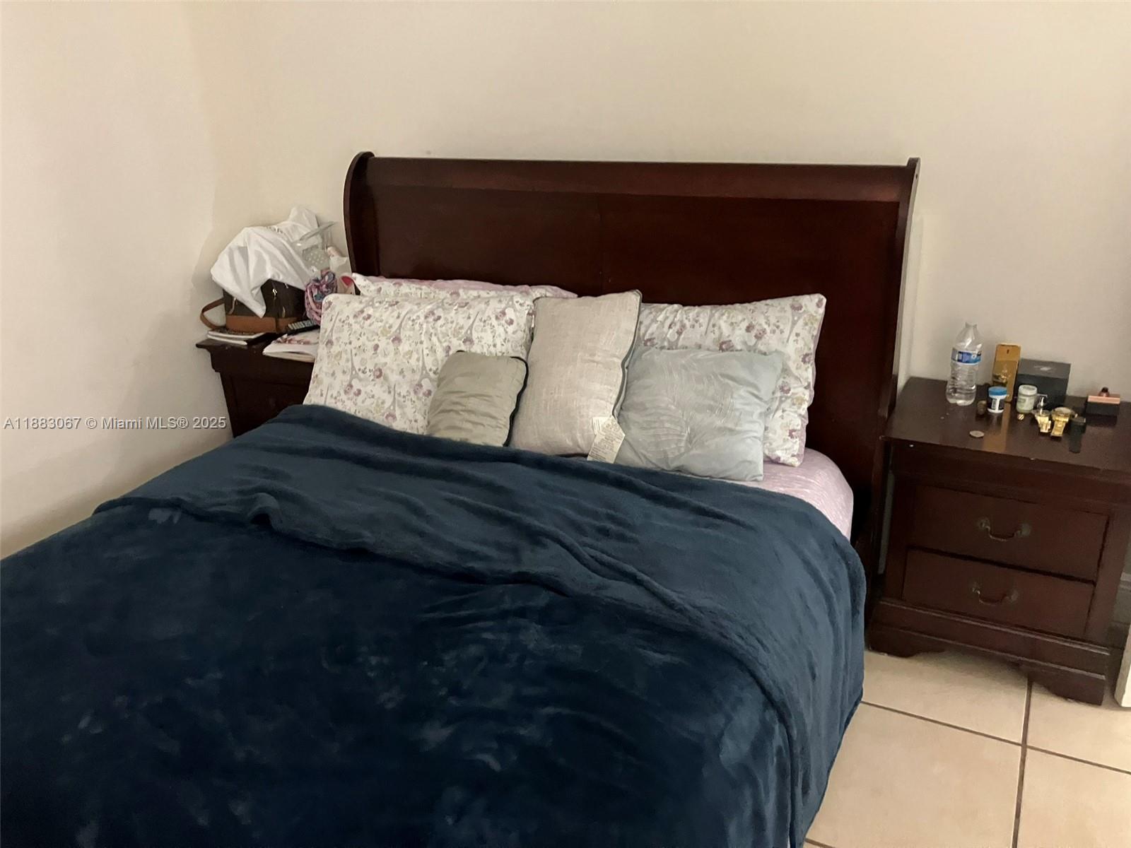 9311 Southwest 4th Street, Unit 104B Miami, FL 33174 - Photo 7 of 21 a bedroom with a bed and a night stand