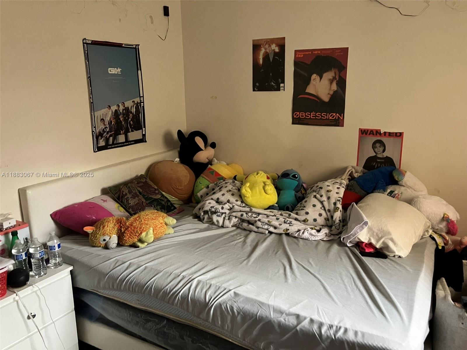 9311 Southwest 4th Street, Unit 104B Miami, FL 33174 - Photo 8 of 21 a bedroom with two beds and painting on the wall