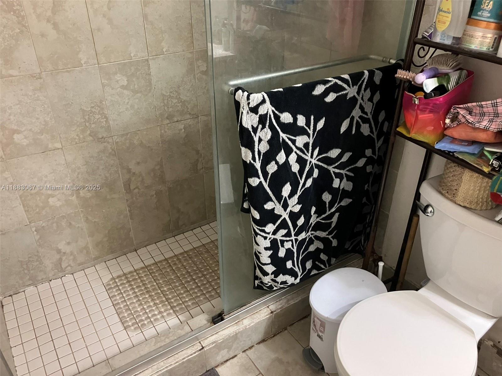 9311 Southwest 4th Street, Unit 104B Miami, FL 33174 - Photo 10 of 21 a bathroom with a toilet and shower