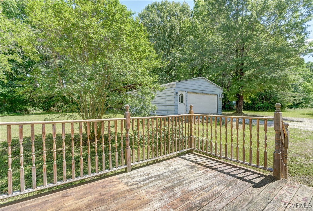 4509 Lockin Road Powhatan, VA 23139 - Photo 28 of 38 Deck featuring a garage, an outbuilding, and a yar