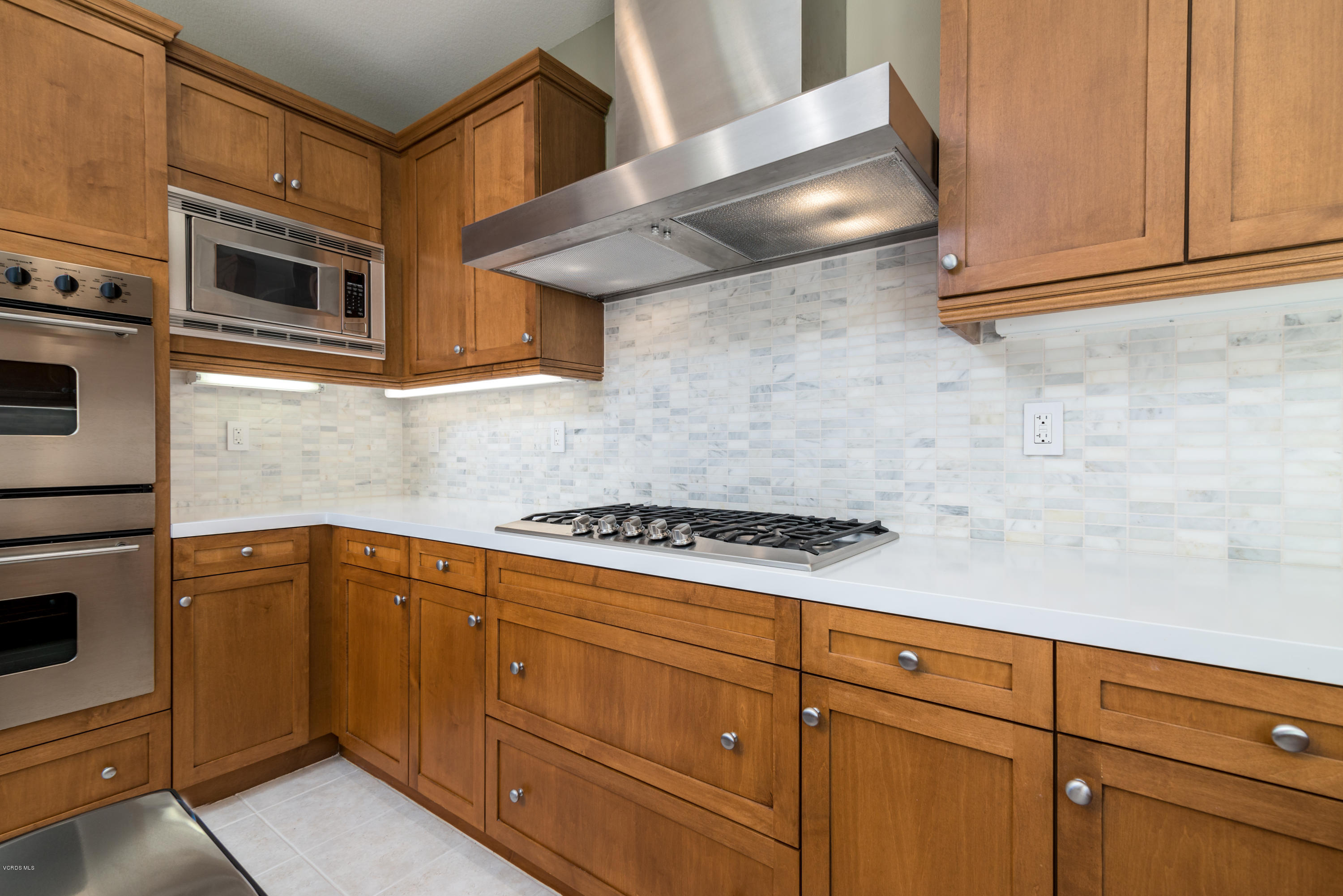 258 Spruce Circle Simi Valley, CA 93065 - Photo 13 of 46 a kitchen with granite countertop cabinets and stainless steel appliances