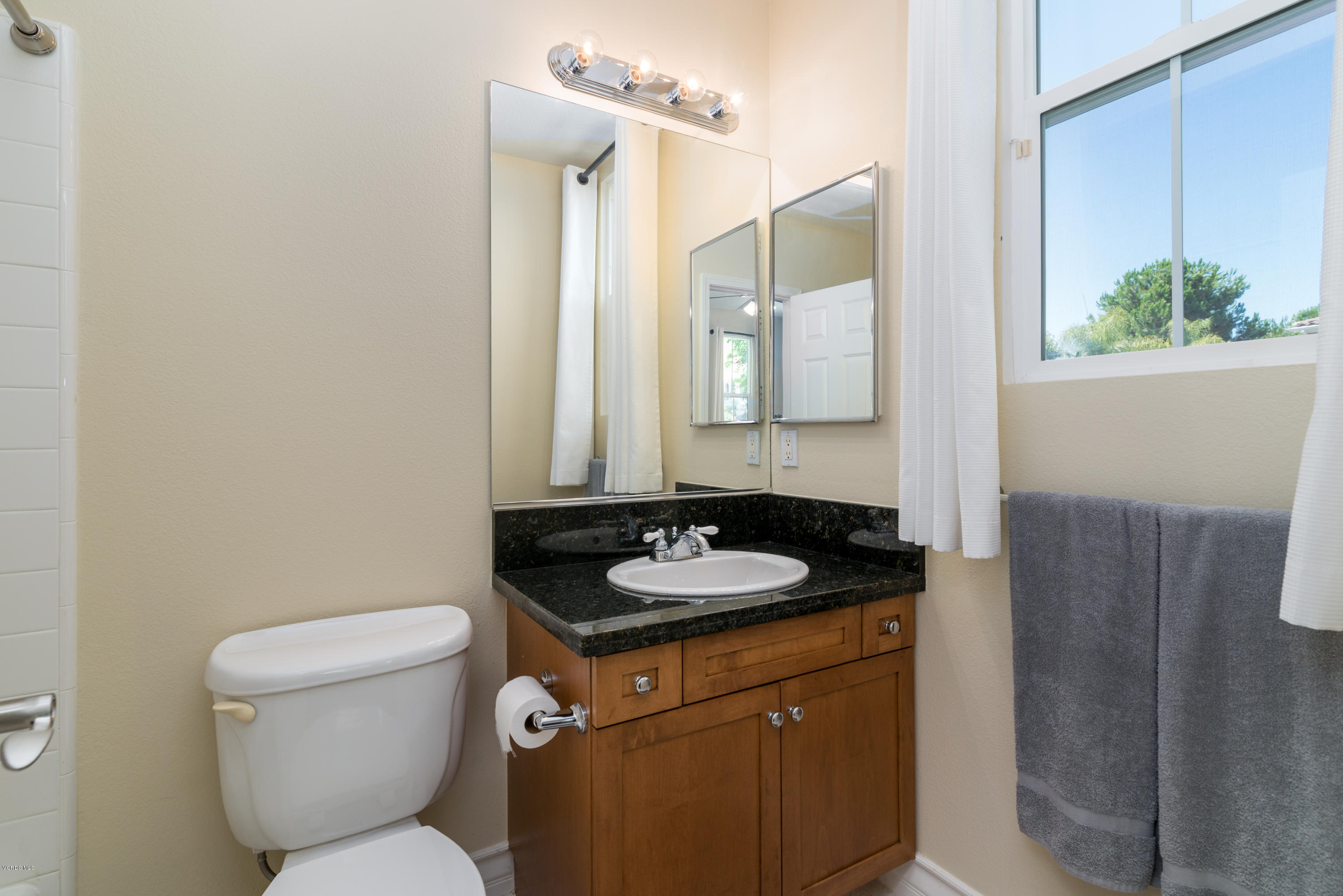 258 Spruce Circle Simi Valley, CA 93065 - Photo 20 of 46 a bathroom with a granite countertop sink and a mirror