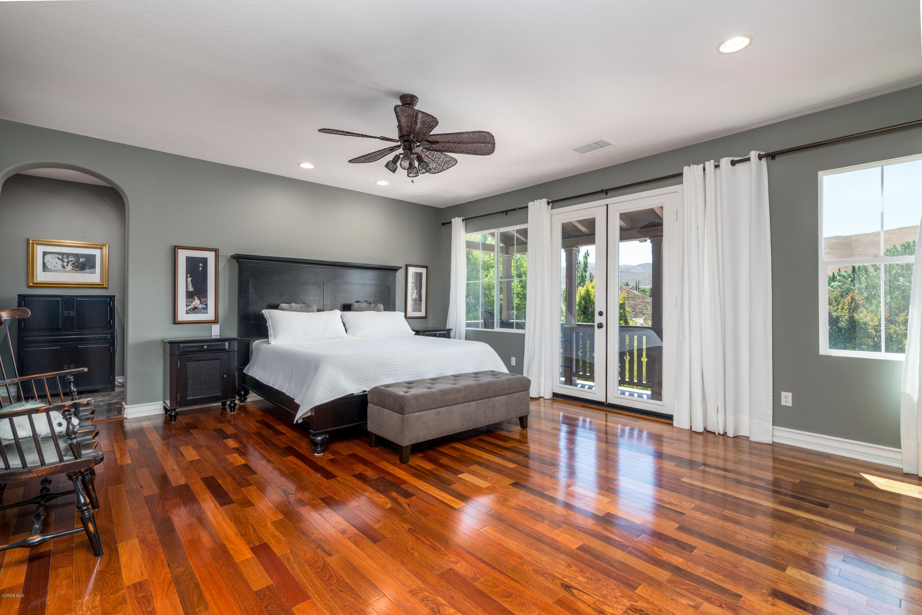 258 Spruce Circle Simi Valley, CA 93065 - Photo 28 of 46 a bedroom with a large bed and a chandelier