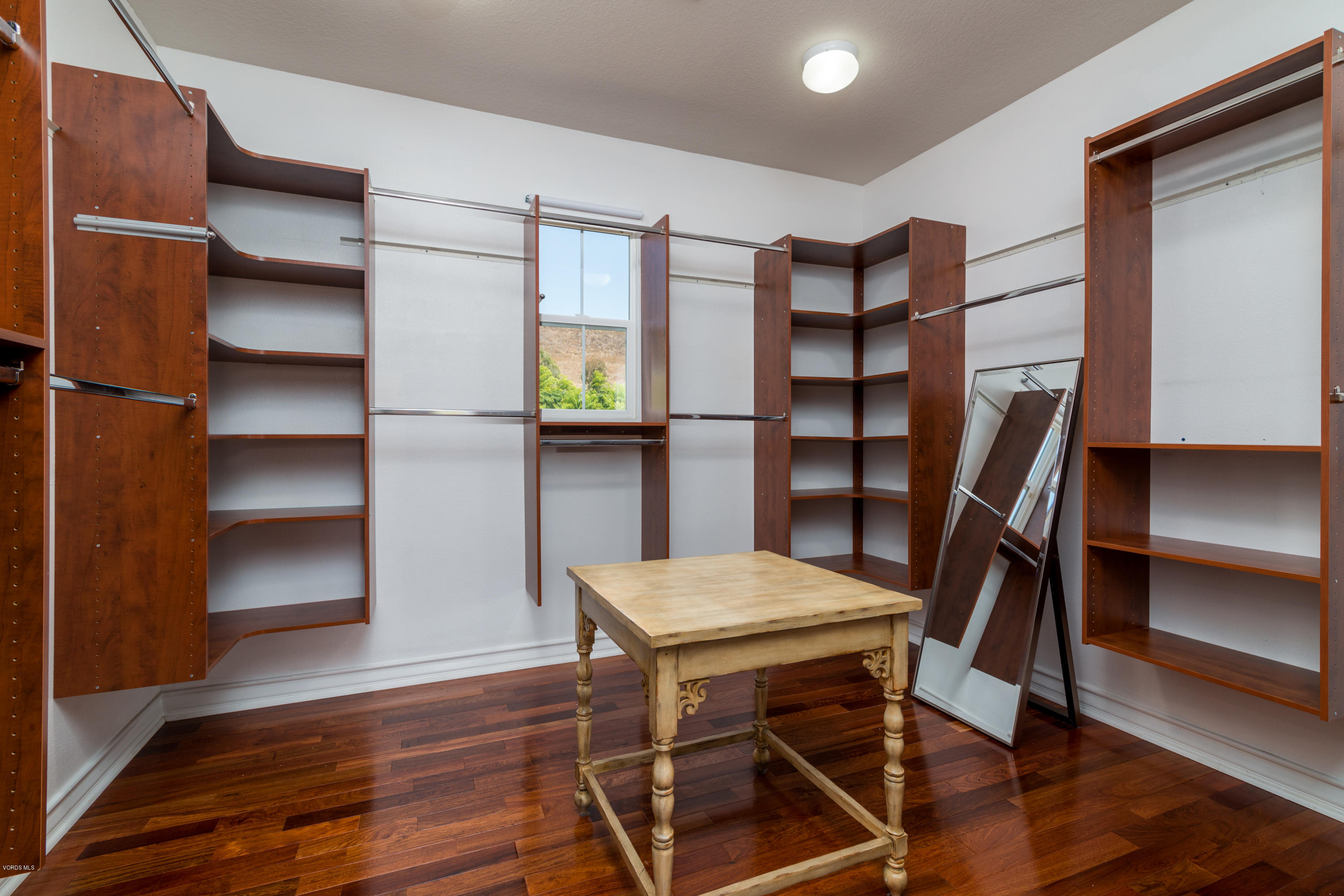 258 Spruce Circle Simi Valley, CA 93065 - Photo 31 of 46 a view of a room with shelves and wooden floor