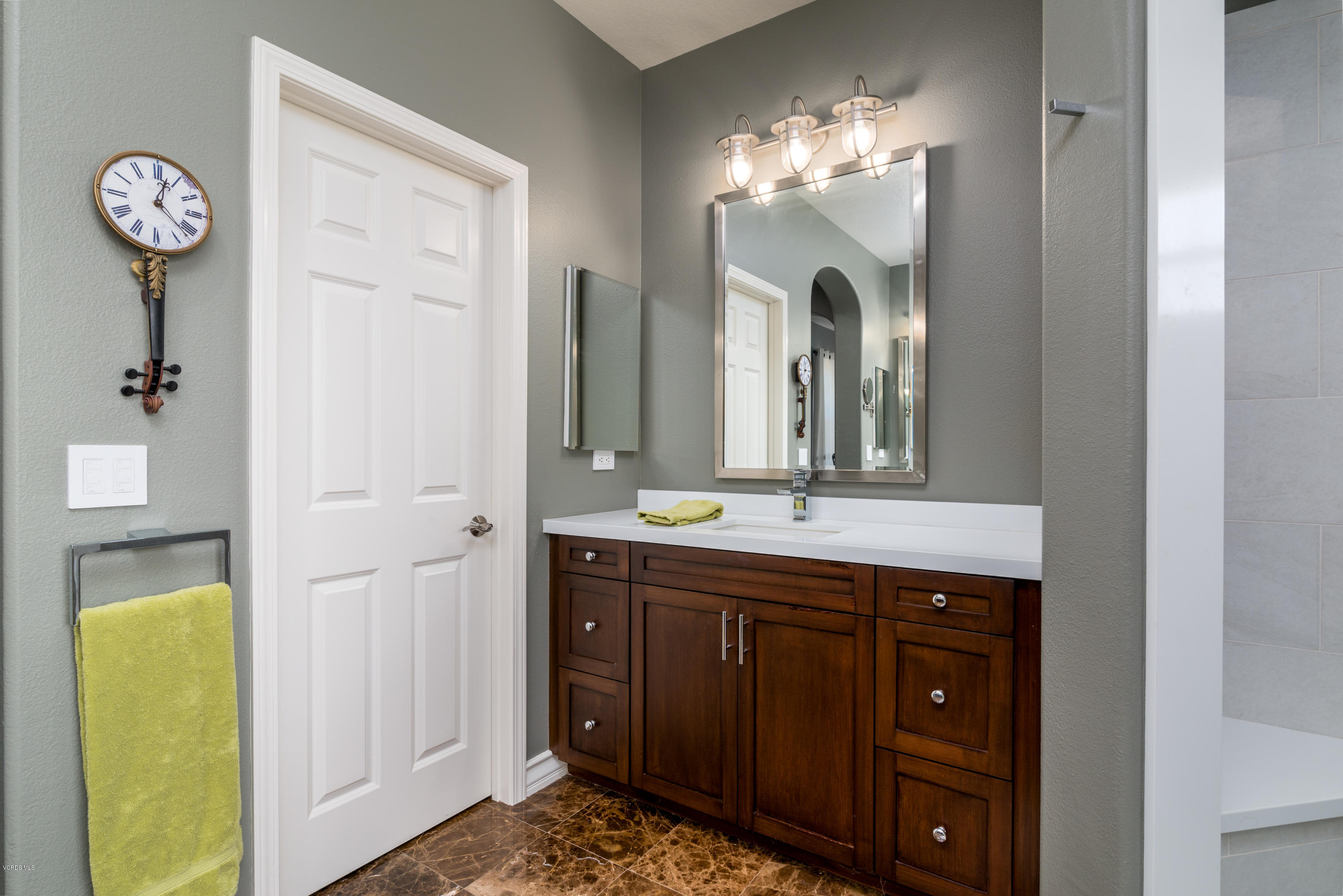 258 Spruce Circle Simi Valley, CA 93065 - Photo 33 of 46 a bathroom with a granite countertop sink a mirror and a shower