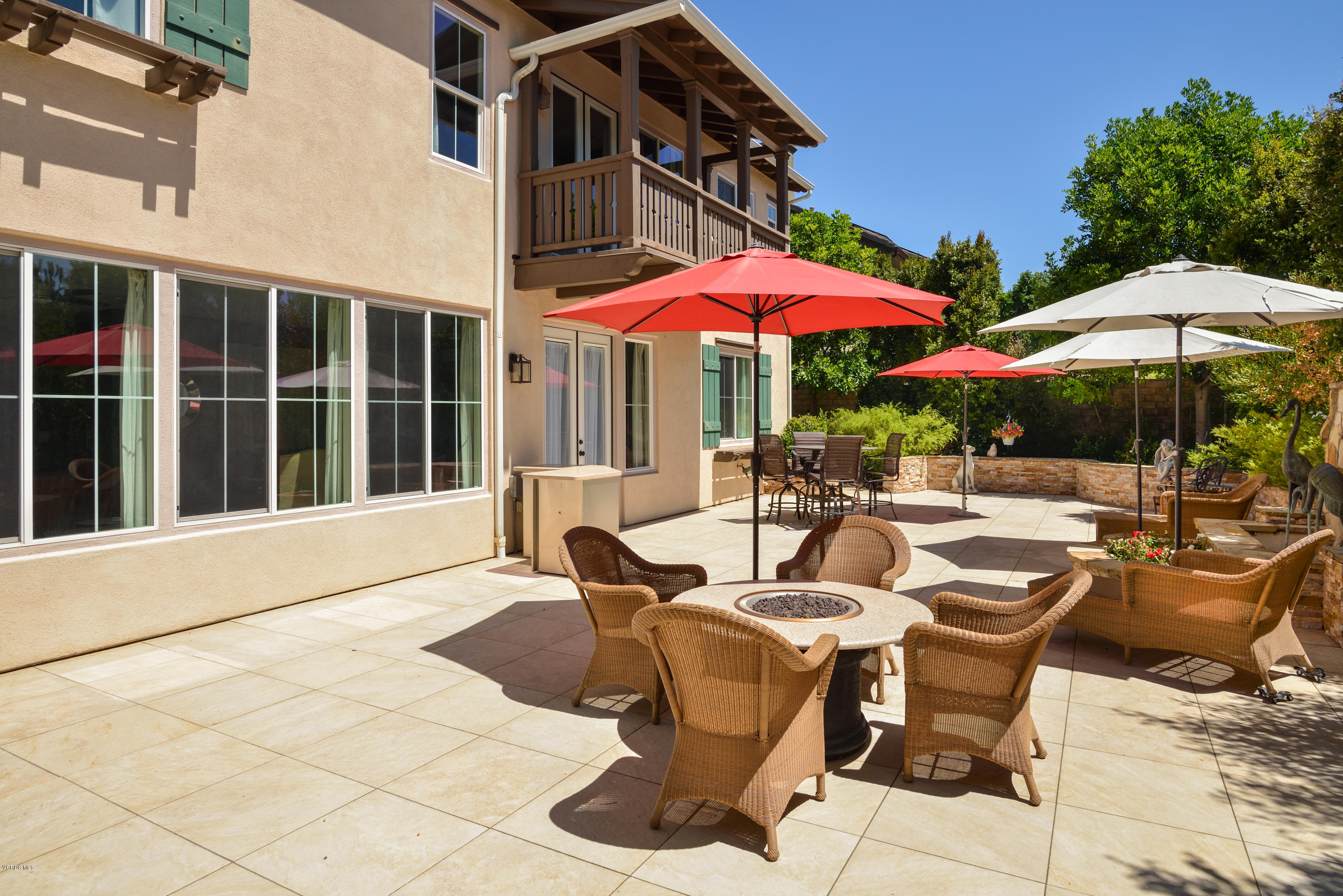 258 Spruce Circle Simi Valley, CA 93065 - Photo 36 of 46 a view of a patio with chairs and table under an umbrella with a barbeque