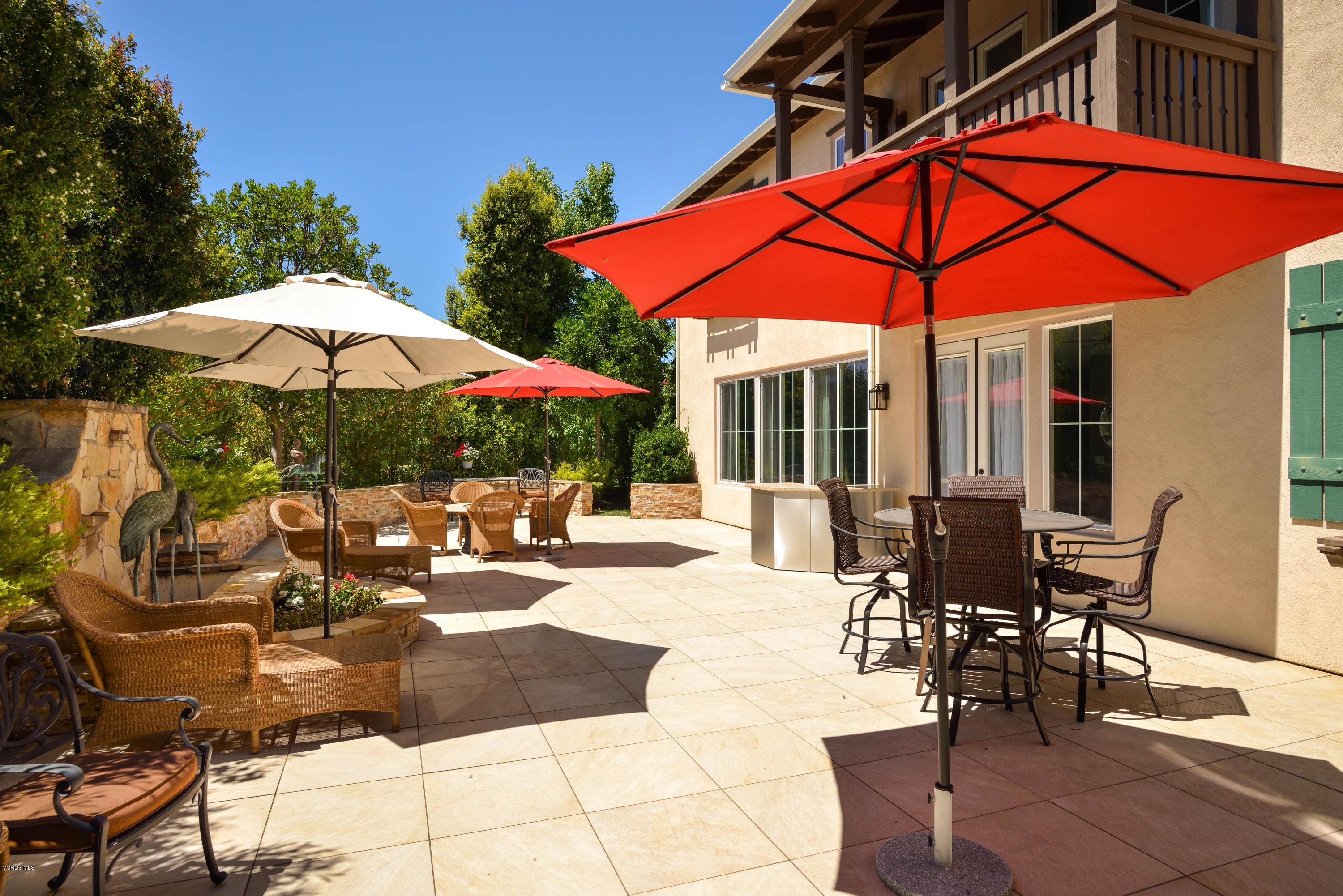 258 Spruce Circle Simi Valley, CA 93065 - Photo 37 of 46 a view of the patio with dining table and chairs under an umbrella