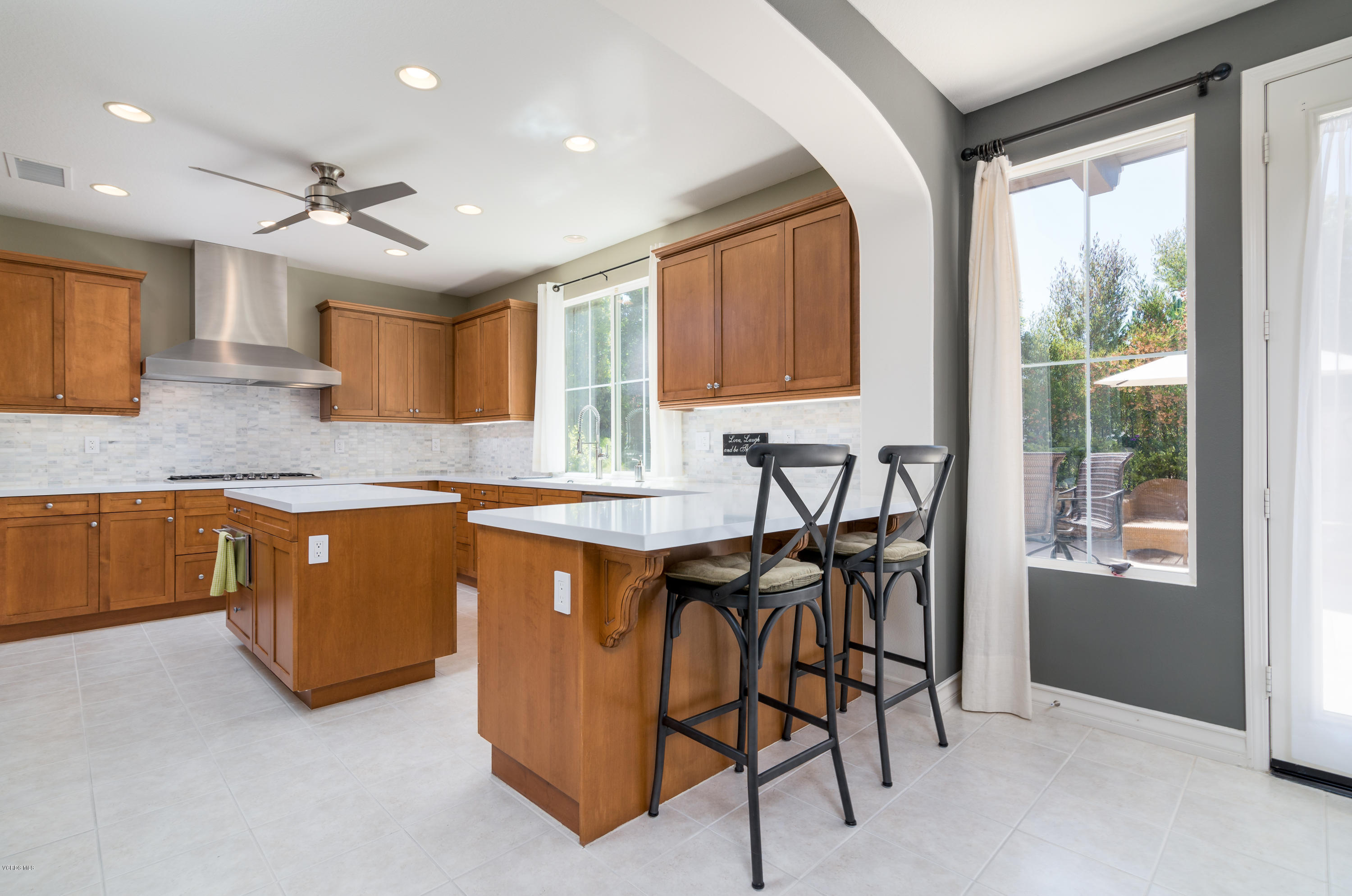 258 Spruce Circle Simi Valley, CA 93065 - Photo 10 of 46 a kitchen with stainless steel appliances granite countertop wooden cabinets a table and chairs