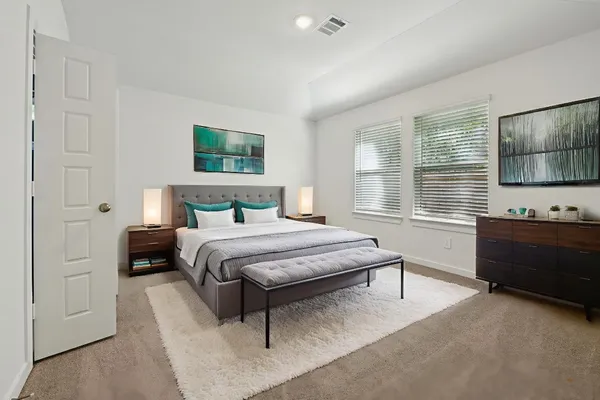 a bedroom with a bed and a window