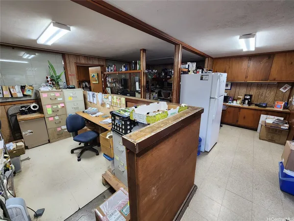 a living room with stainless steel appliances kitchen island granite countertop furniture and a view of kitchen