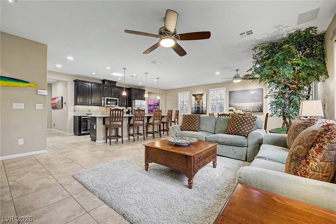 7415 Campbell Ranch Avenue Las Vegas, NV 89179 - Photo 15 of 52 An open concept living area seamlessly blends the kitchen and family room, creating a perfect space for entertaining.
