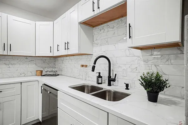 a kitchen with a sink and cabinets