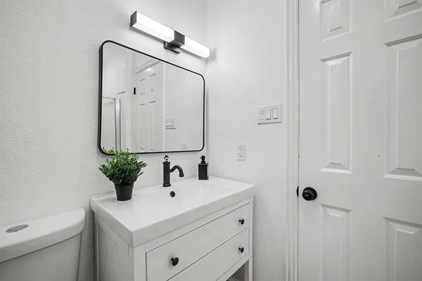 a bathroom with a sink vanity and a mirror