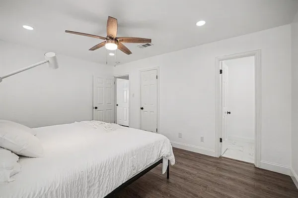 a bedroom with a bed and a ceiling fan
