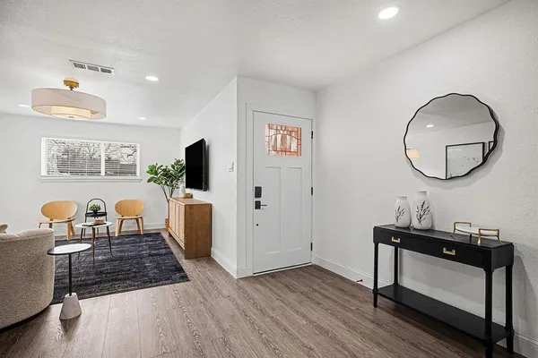 a living room with furniture and a mirror