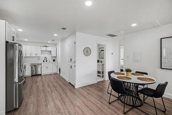 a kitchen with a table and chairs in it
