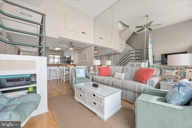 a living room with furniture and kitchen view