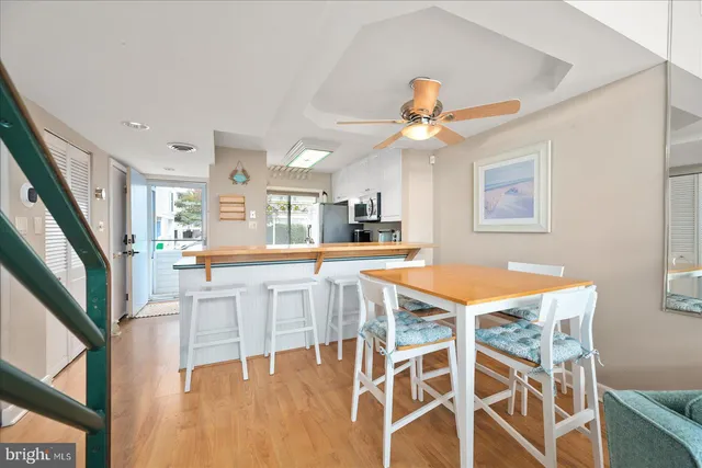 a view of a dining room with furniture and a chandelier