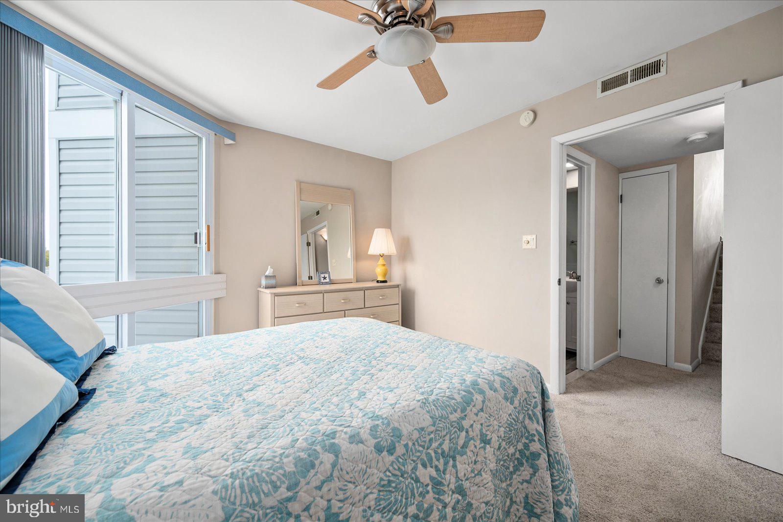 775 94th Street, Unit 775 Ocean City, MD 21842 - Photo 21 of 57 a bedroom with a large bed and a chandelier